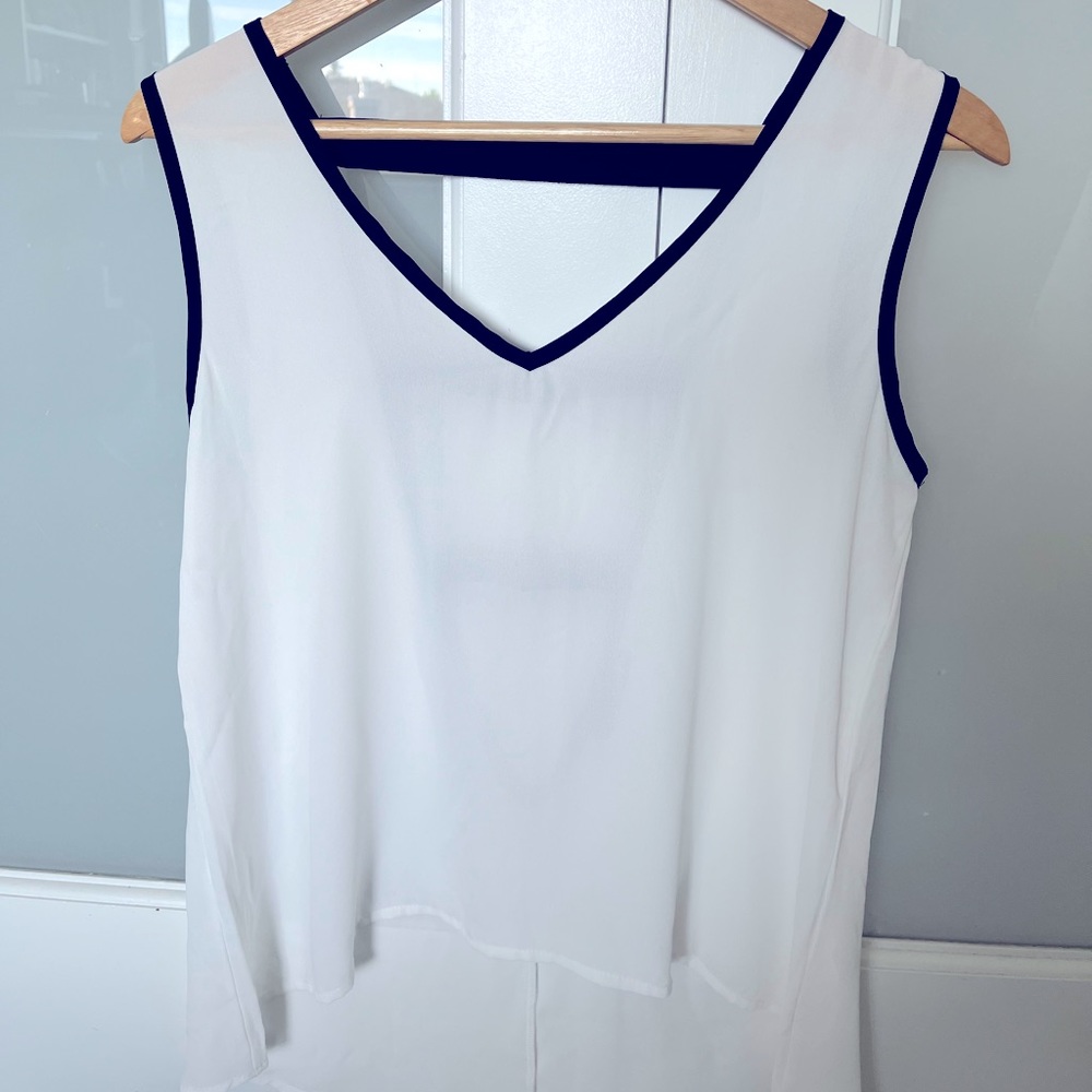 Women’s v-neck white sleeveless top with black trim detail, size small.